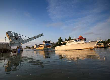 The drawbridge at Knapps Narrows on Tilghman Island in Talbot County, Maryland, raises for a fishing boat.